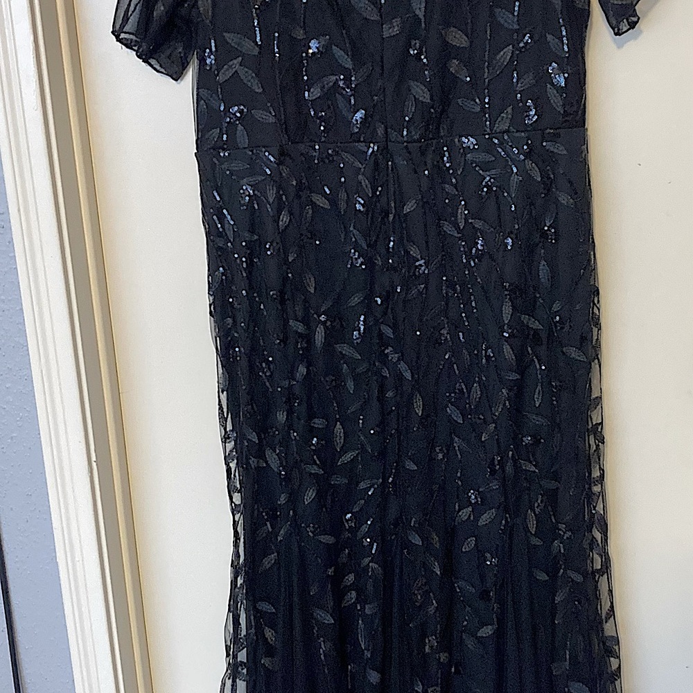 This is a formal ankle length black dress. It’s a size 18 but it fits like a 16.